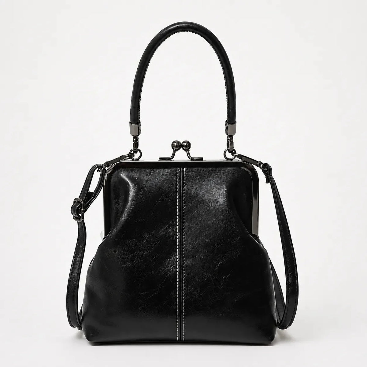 Black kiss-lock crossbody bag with top handle and leather shoulder strap