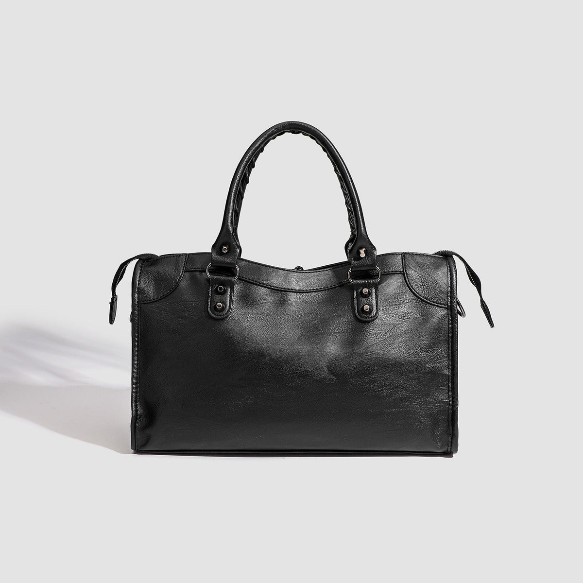 Black vegan leather handbag with top handles and minimal front design