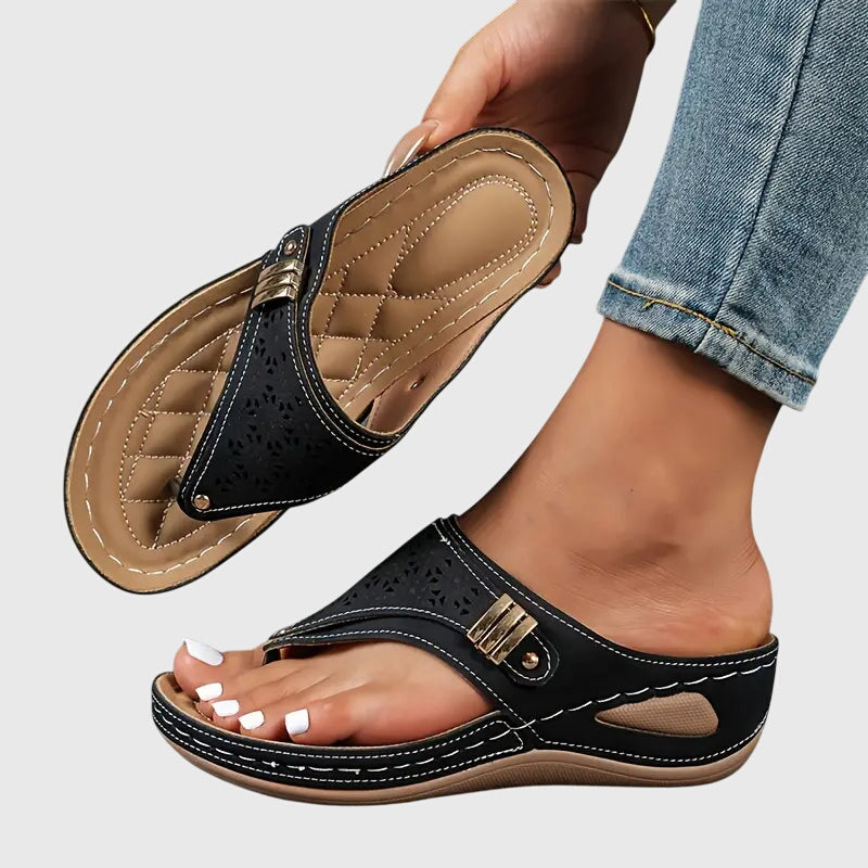 Black orthopedic slide sandals with perforated upper and adjustable hook strap