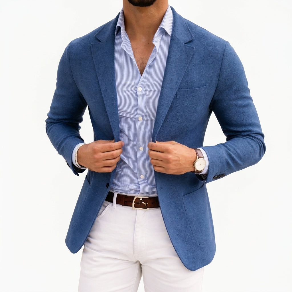 Blue knit blazer with notch lapels and front pockets, worn over a striped shirt.