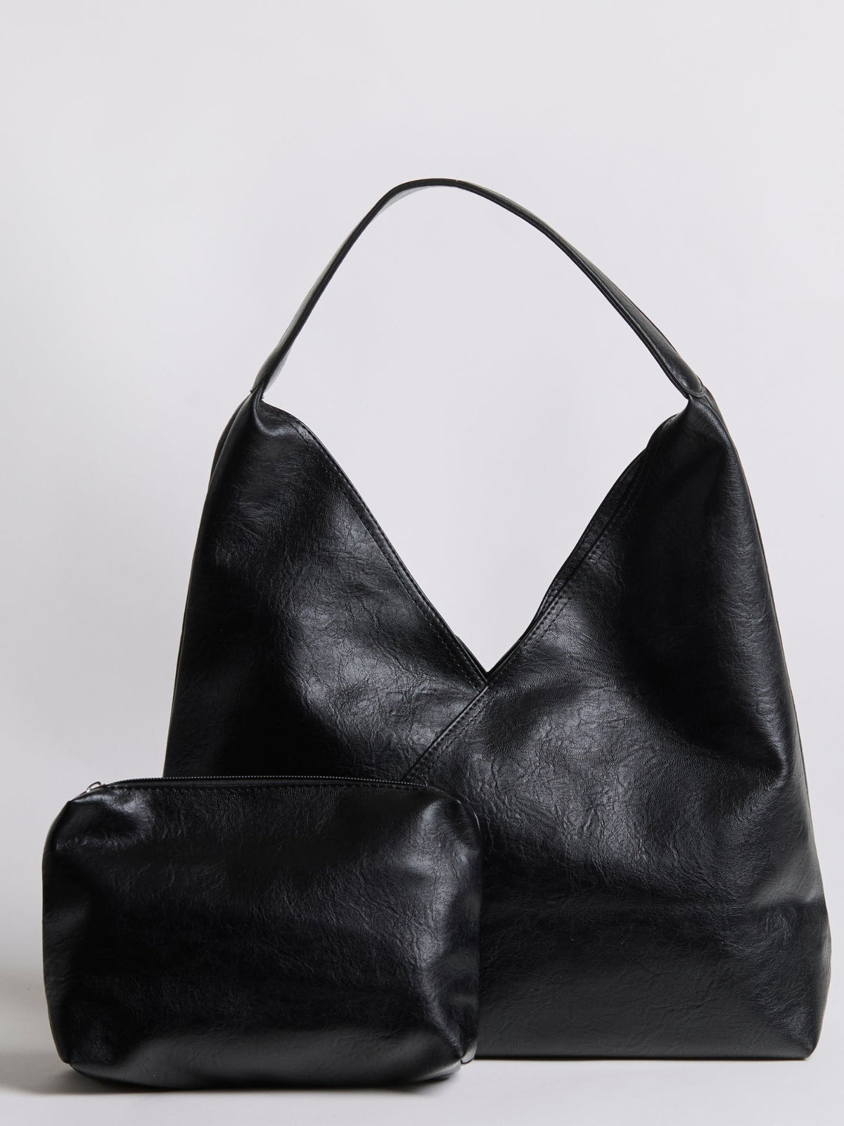 Black leather shoulder bag with short handles and matching zip pouch.