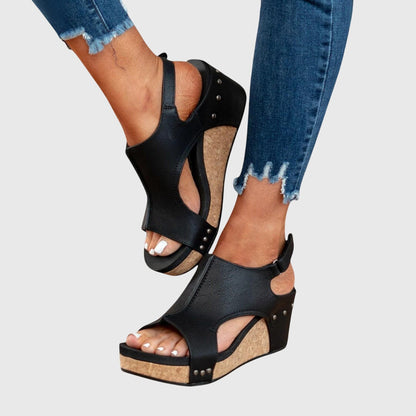 Black orthopedic sandals with ankle strap and stud trim on wedge heel