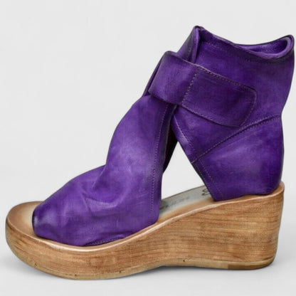 Purple orthopedic wedge sandal shown from the side with adjustable strap buckles