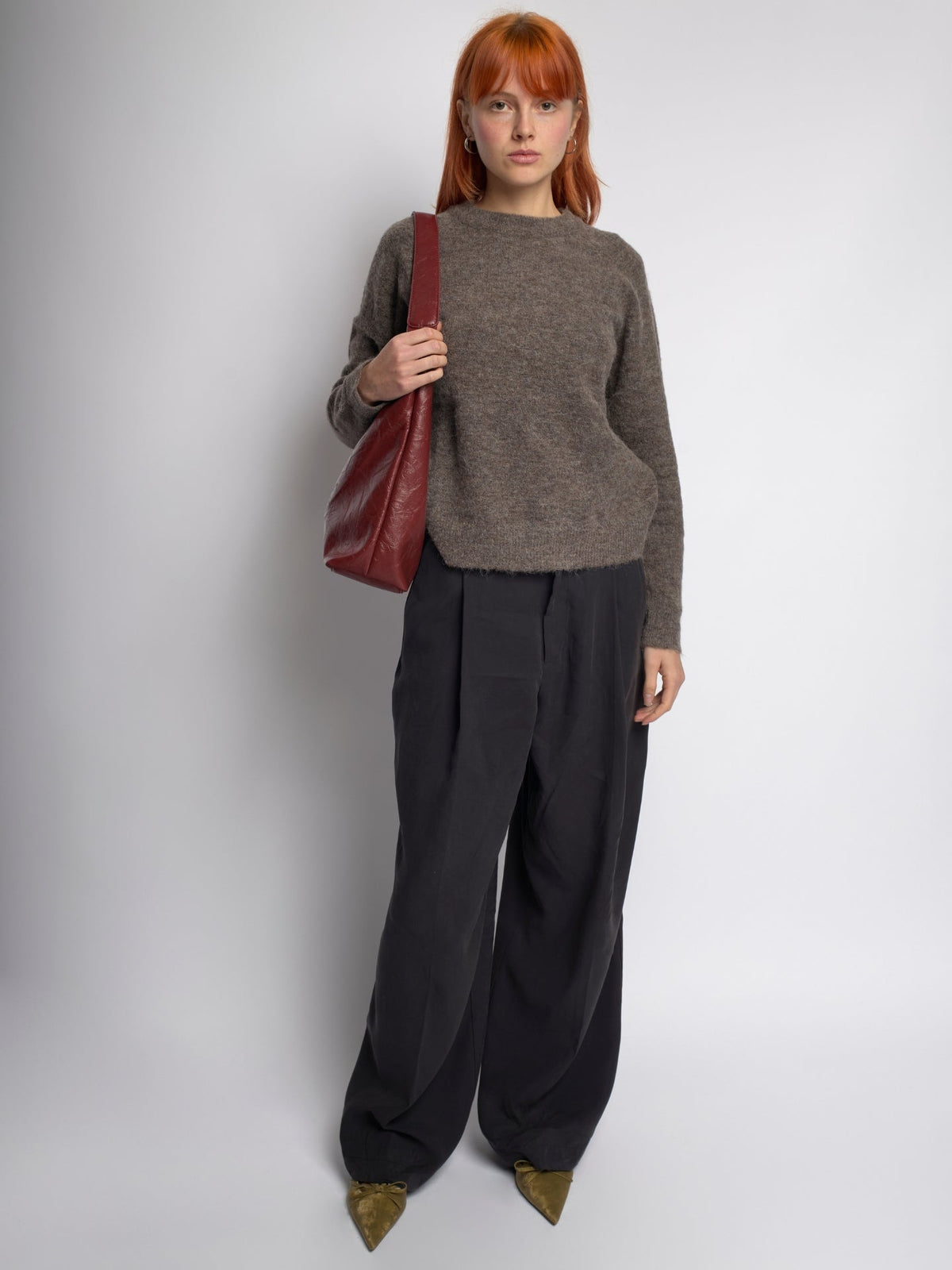 Burgundy distressed vegan leather tote with top handle and soft slouch