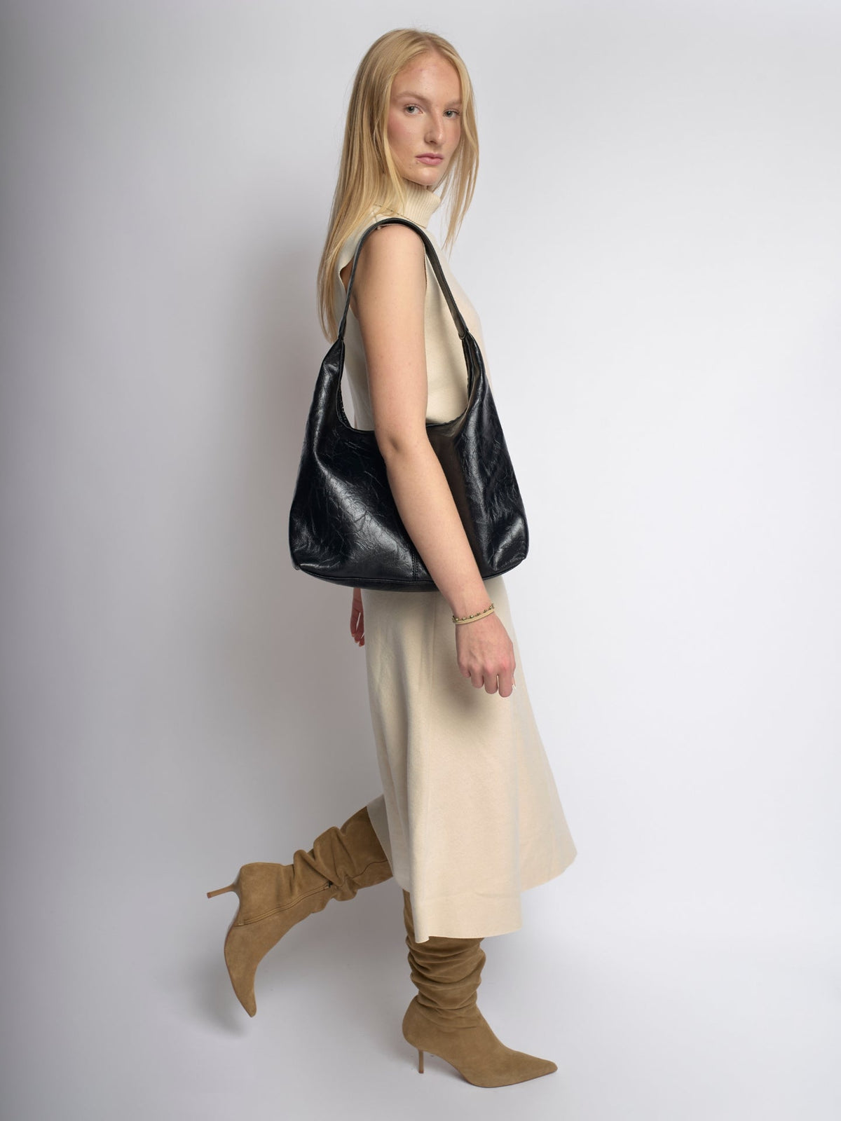 Black distressed vegan leather tote bag in side view with top handles