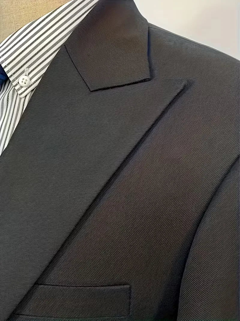 Black suit jacket lapel and shoulder detail with subtle textured fabric