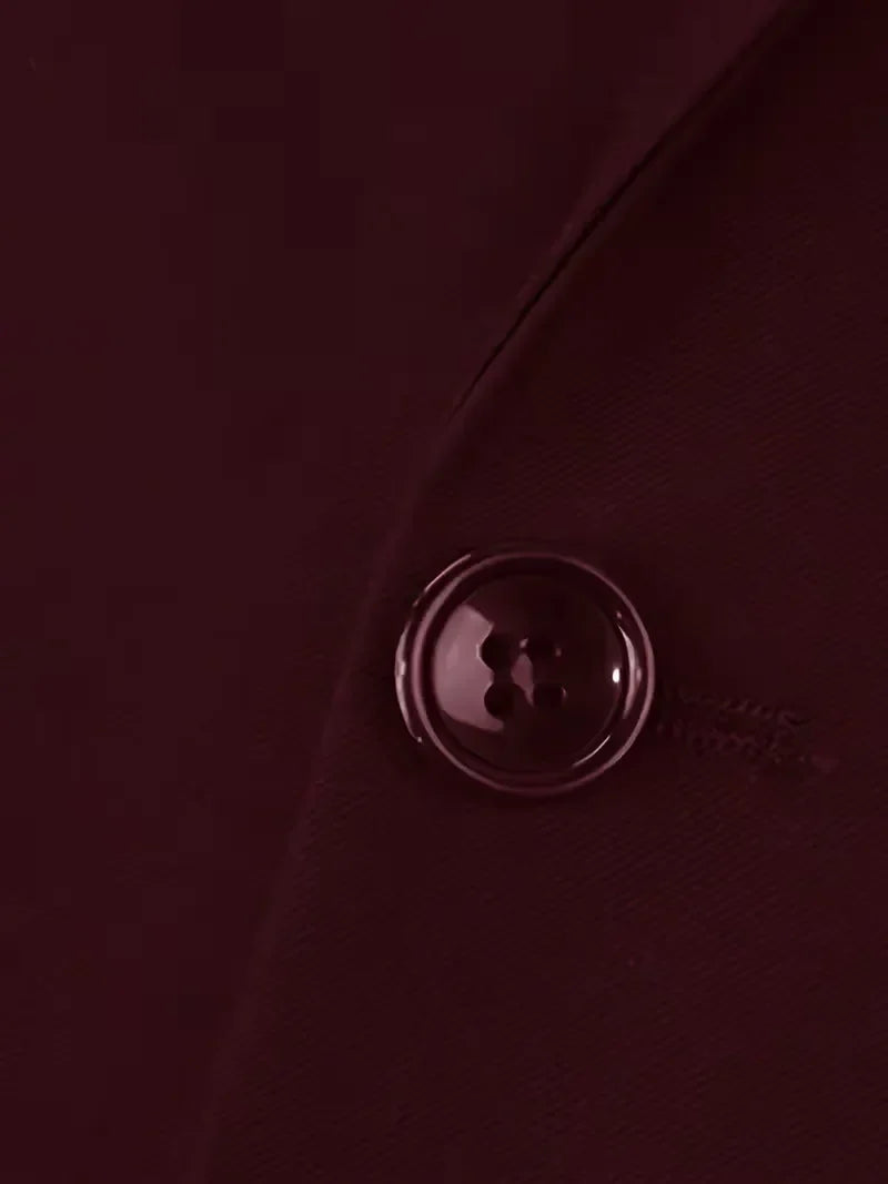 Burgundy waistcoat button detail with glossy metal shank