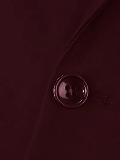 Burgundy waistcoat button detail with glossy metal shank
