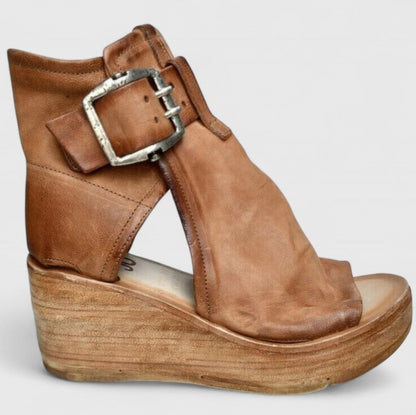 Brown orthopedic wedge sandal with silver-toned buckle strap and open toe