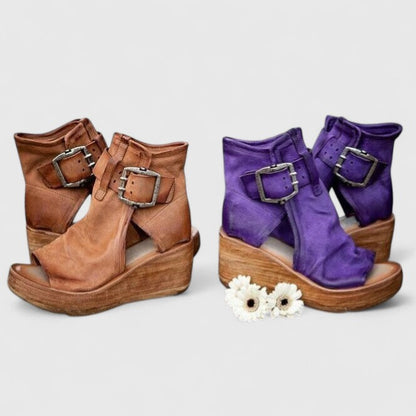 Pair of wedge sandals in brown and purple, each with adjustable buckle straps