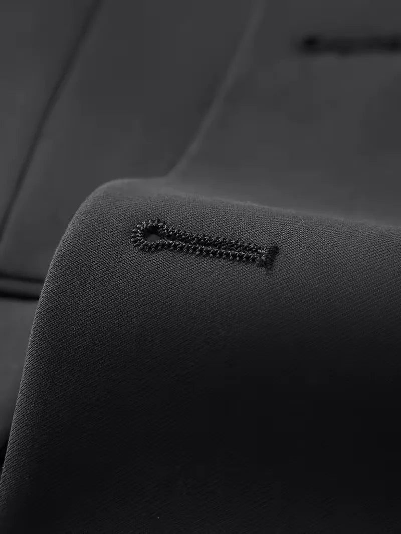 Black jacket buttonhole and small decorative stitch detail on suit fabric