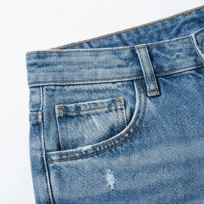 Front pocket and waistband detail on women's cropped light blue denim jeans