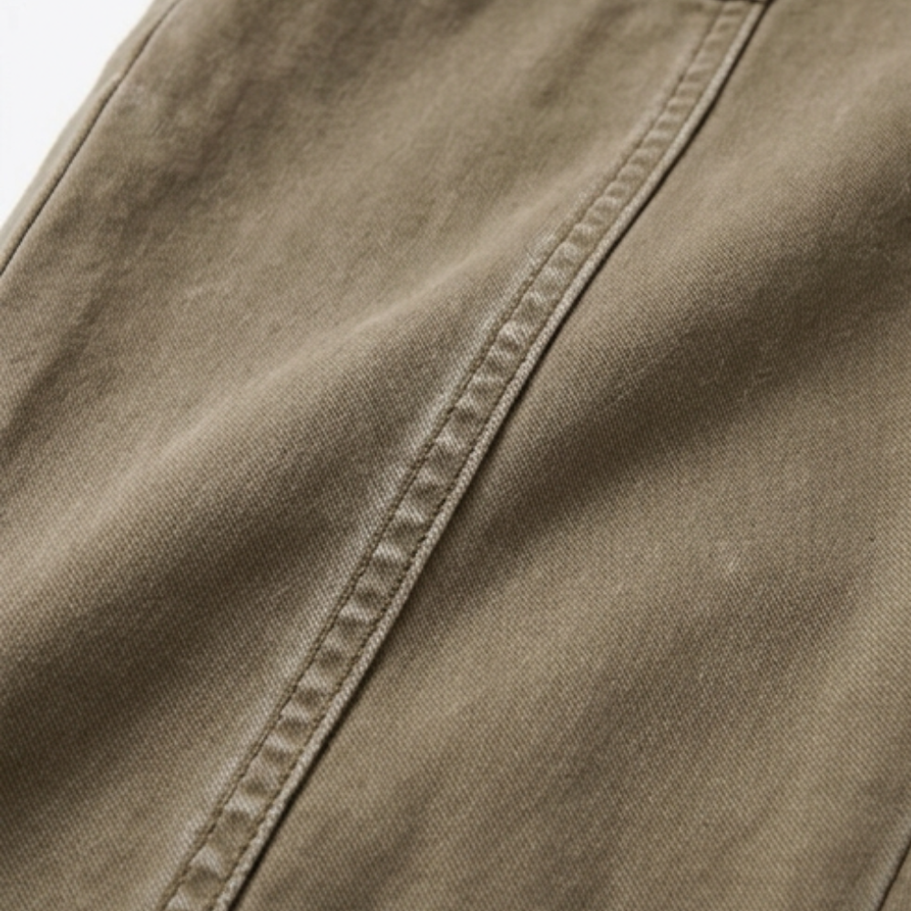 Warm khaki pants fabric close-up with side seam and stitching