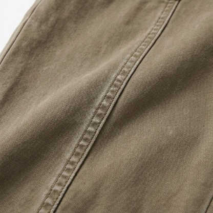 Warm khaki pants fabric close-up with side seam and stitching
