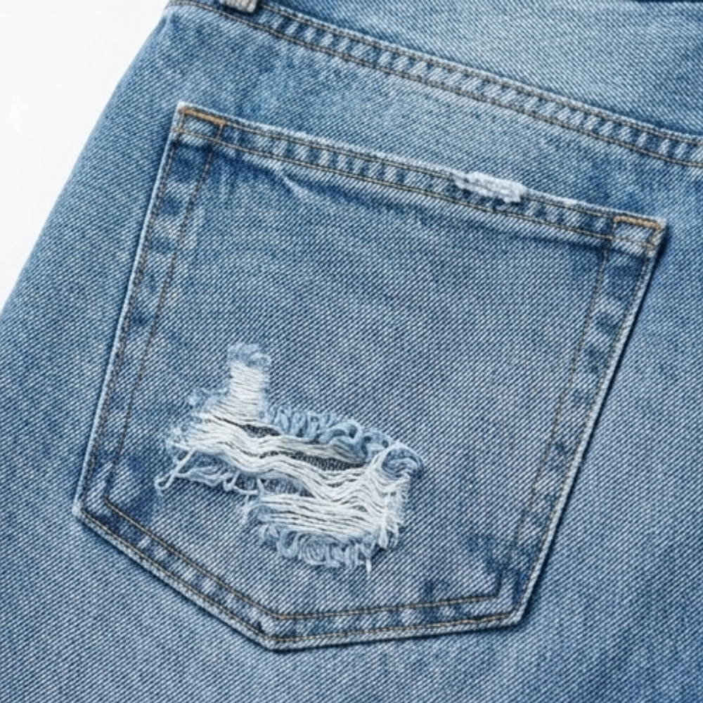 Back patch pocket detail on women's cropped jeans, light blue denim with distressed stitching