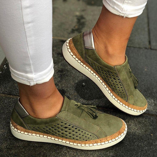 Orthopedic green slip-on shoes with perforated sides, tassel detail, and beige sole