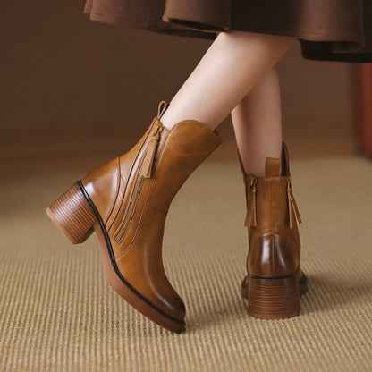 Brown ankle boots with side zipper and tassel detail, showing back heel