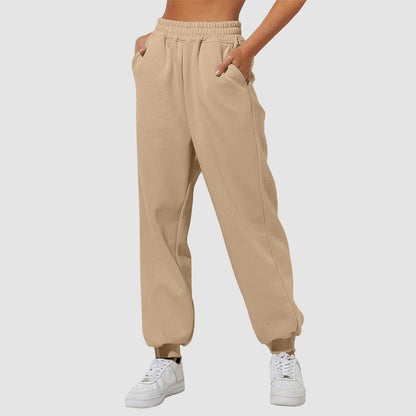 Beige sweatpants with elastic waistband, drawstring, and cuffed ankle hems.