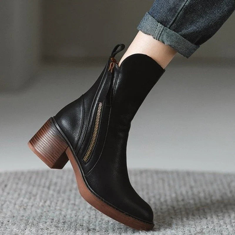 Black ankle boots with side zipper, tassel pull, and stacked block heel