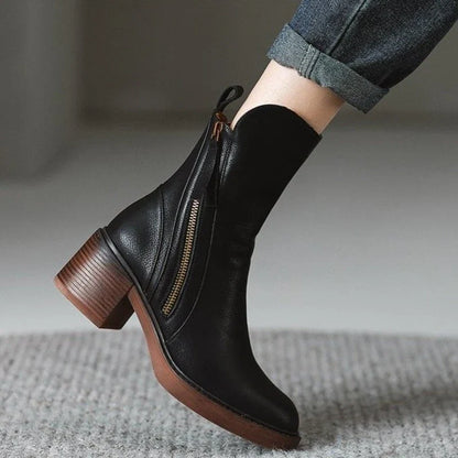 Black ankle boots with side zipper, tassel pull, and stacked block heel