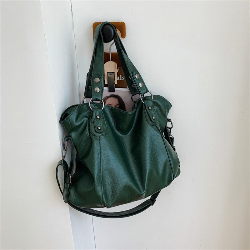 Green vegan leather handbag with two handles and detachable shoulder strap