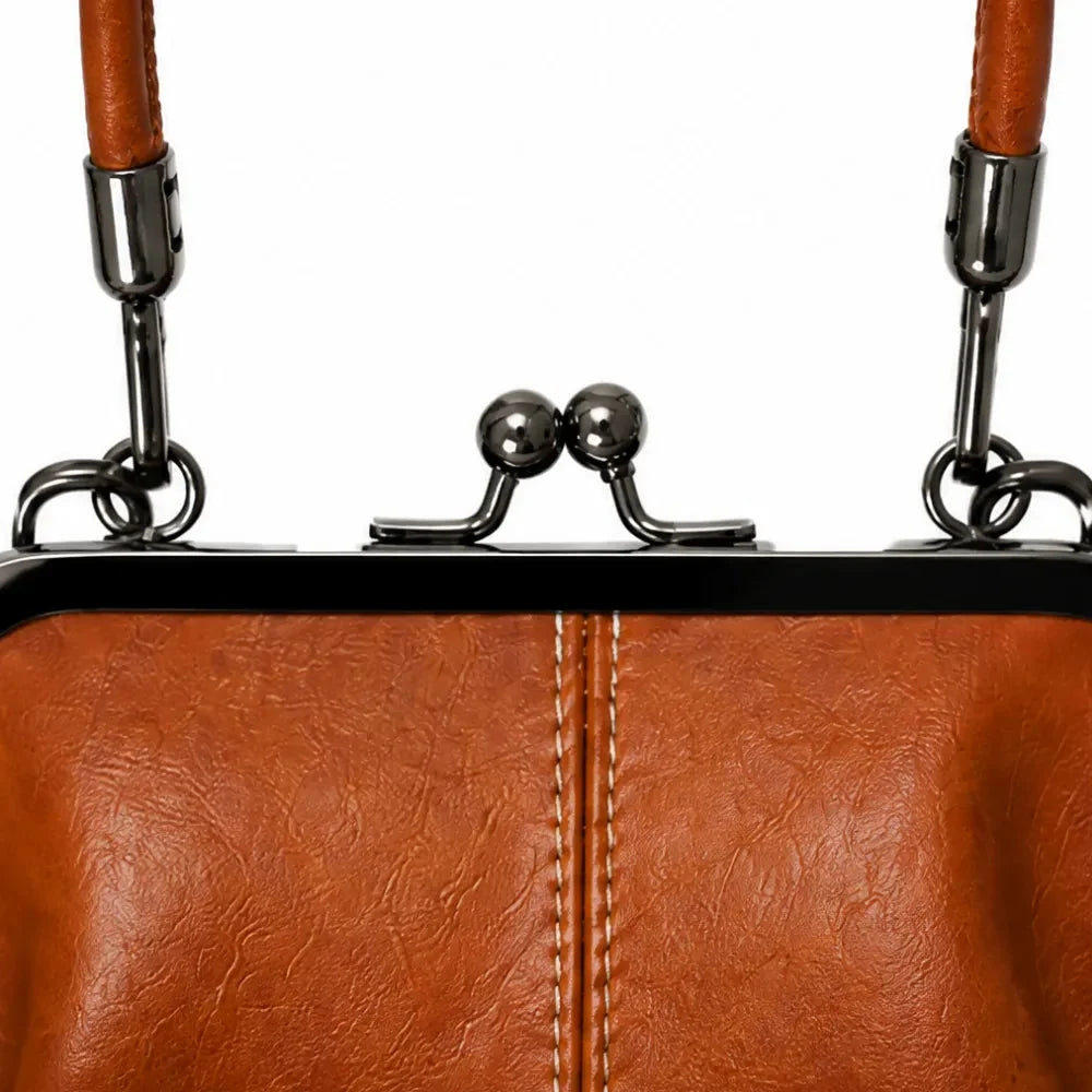 Cognac brown bag frame with metal kiss-lock clasp and strap attachment loops