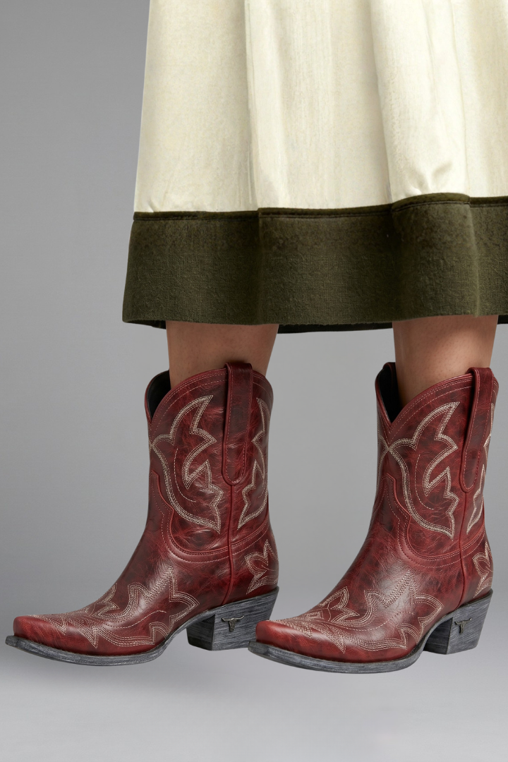 Women’s embroidered ankle boots in red-brown leather, front view with stitched motifs