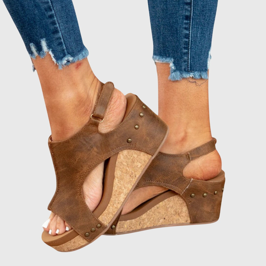 Brown orthopedic wedge sandals with arch support, open toe, and studded straps