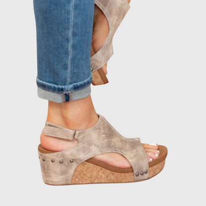 Beige orthopedic sandals with stud accents on side straps and wedge sole