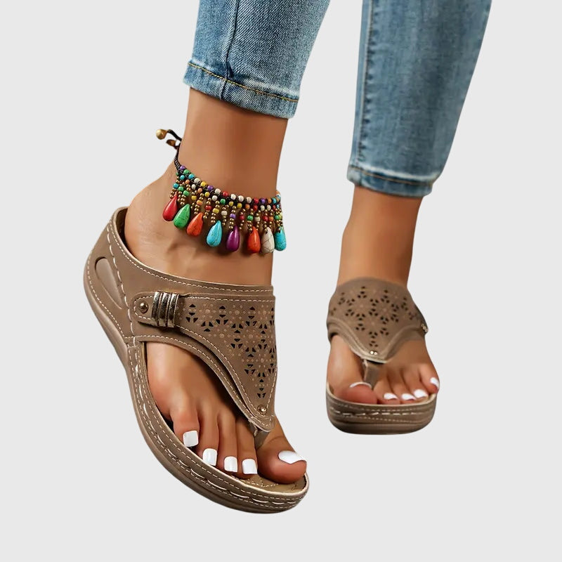 Tan orthopedic slide sandals with perforated upper and wide strap