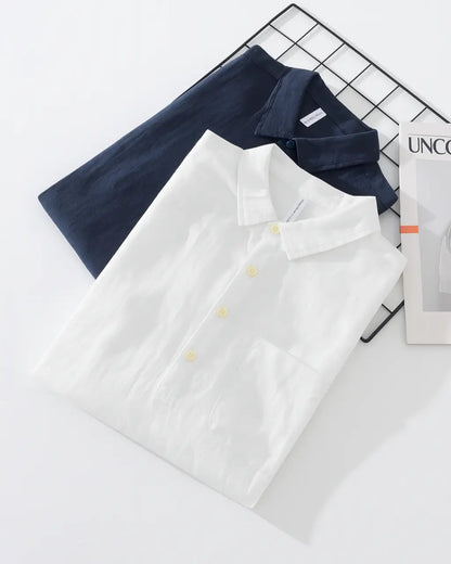 Men’s white and navy cotton-linen popover shirts, flat lay with collars and buttons