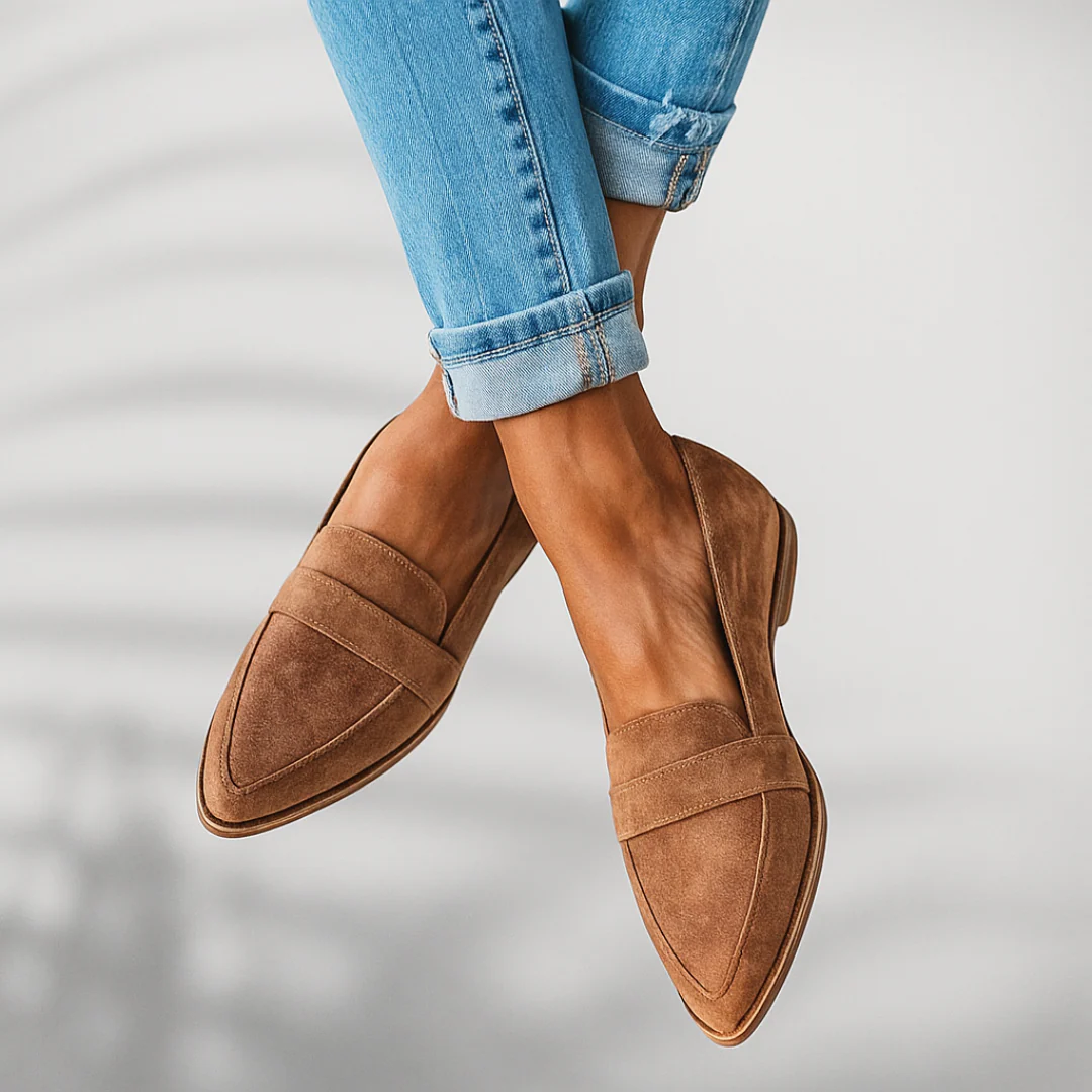 Tan suede slip-on loafers, side profile with stitched seams and brown sole