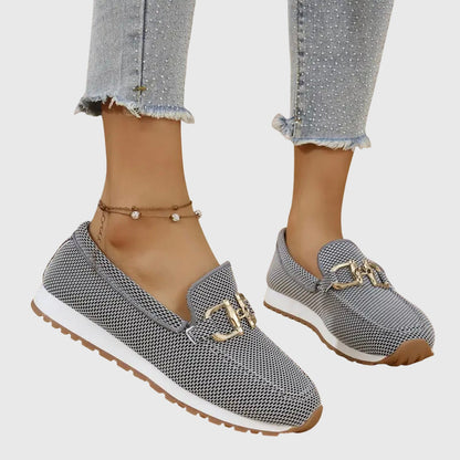 Grey textured ladies loafers with gold buckle trim and low-profile outsole