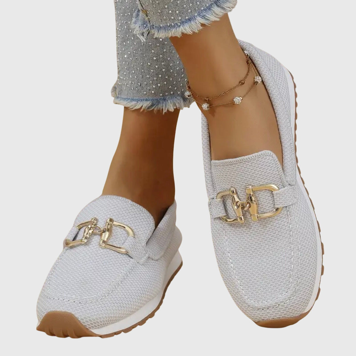 White textured ladies loafers with gold buckle detail and padded low sole