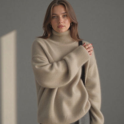 Cream/beige oversized roll-neck cashmere jumper, arm-up pose and ribbed cuffs